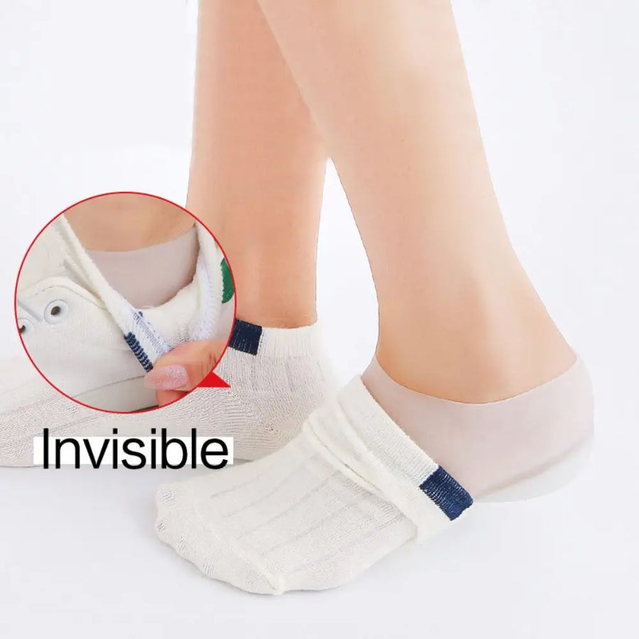 Heel lift hidden under an ankle sock inside a white sneaker