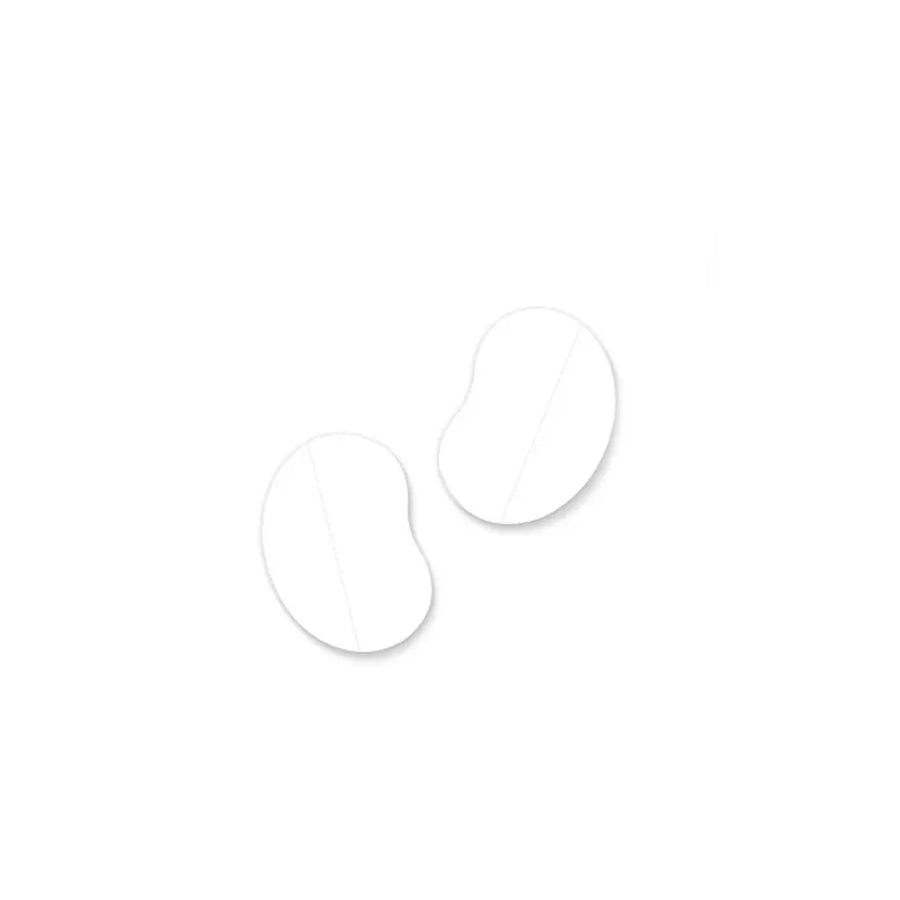Two white silicone ear corrector pads on a white background