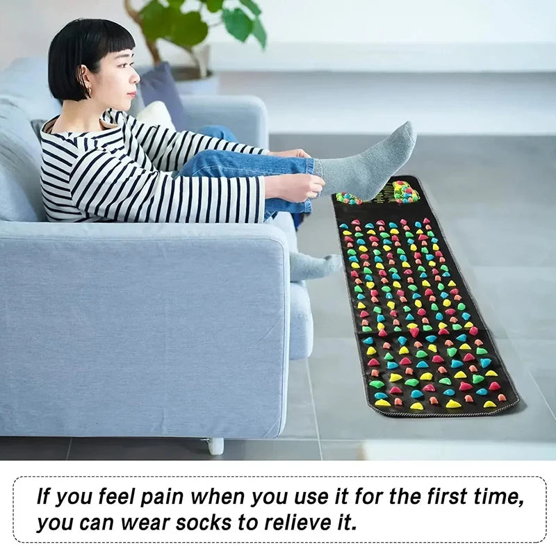Woman on a sofa resting her socked feet on the long stone mat