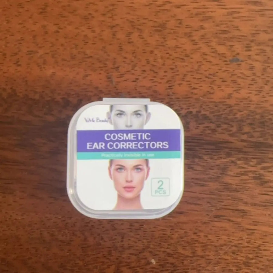 Ear corrector packaging box photographed on a wooden surface