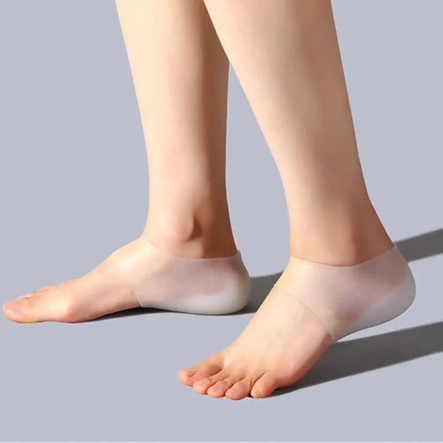 Pair of feet wearing clear silicone heel lifts